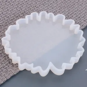 Vista detallada de un molde de silicona blanco con borde ondulado para posavasos DIY.