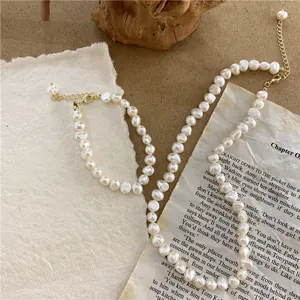 Close-up view of a vintage baroque natural pearl necklace and bracelet jewelry set