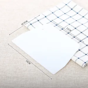 White plastic trapezoidal dough scraper with size markings 15x11x10.5cm for baking