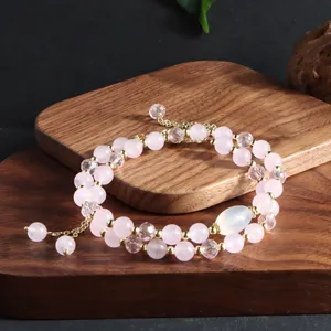 Detailed view of natural rose quartz double-layer bracelet with elegant gold-tone spacers.