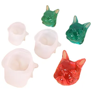 Close-up of 3D French Bulldog silicone molds alongside finished resin dog head casts.