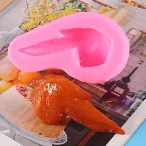 Close-up detail of a pink silicone chicken wing mold with a realistic resin food model