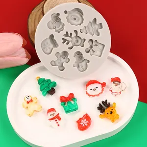 Close-up of Christmas themed silicone mold with various festive resin charms