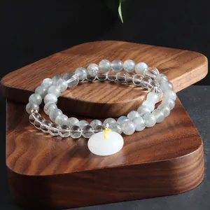 Macro view of double-wrap natural stone bracelet featuring labradorite and crystal beads