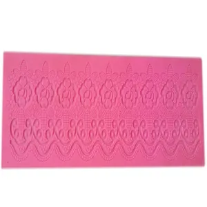 Detail of pink silicone fondant lace mold featuring intricate floral and wave patterns