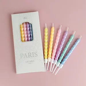 Detail view of six colorful spiral birthday cake candles with Paris themed gift box