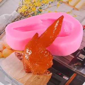Detailed pink silicone mold for creating realistic chicken wing shapes for chocolate crafts