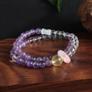 Elegant detail view of a double-layer amethyst and citrine crystal beaded bracelet