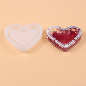 Detailed view of heart-shaped silicone ashtray mold with finished resin sample