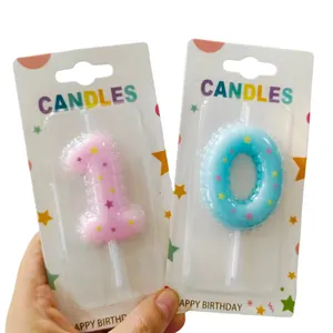 Close-up view of colorful number 1 and 0 birthday candles with star patterns in packaging