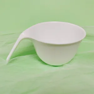 Close-up detail of a white silicone mixing bowl featuring an integrated long handle design