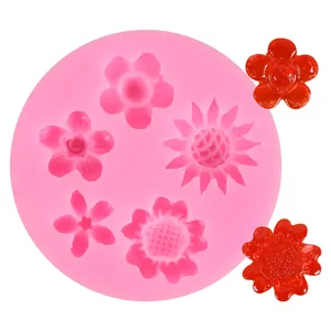 Detail view of pink silicone flower mold with finished red flower samples