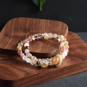 Detail of a stunning double-strand natural quartz crystal bracelet on dark wood.