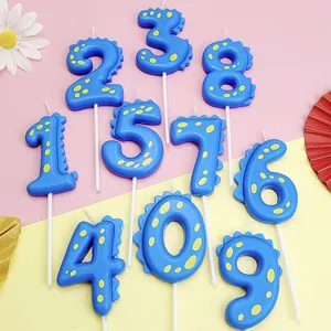 Set de velas azules con números de dinosaurios 0-9 para decorar fiestas infantiles.