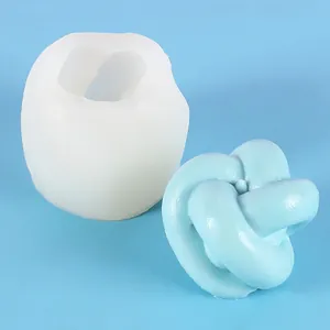 Detail view of a knot-shaped silicone mold with a finished blue resin knot sample