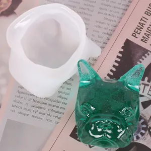 Detail view of 3D French Bulldog head silicone mold and finished green resin ornament.