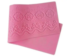 Macro view of pink silicone fondant lace mat with rose pattern for DIY cake decorating