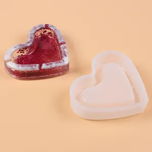Close-up view of a heart-shaped silicone mold with a red glittery resin ashtray result
