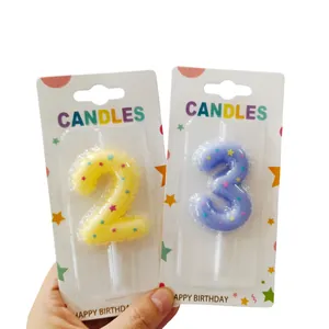 Detail of number 2 and 3 birthday candles with star patterns in balloon shape