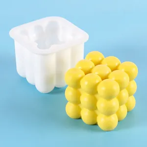 Detail view of a 3D sphere cube silicone mold with a yellow finished sample on blue