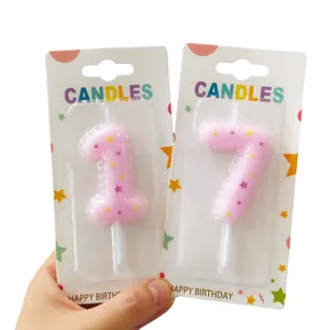Detailed view of pink number 1 and 7 birthday candles with colorful star patterns
