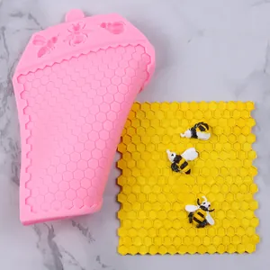 Detail view of pink silicone honeycomb mold with finished yellow bee pattern sheet.