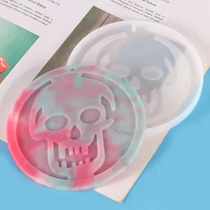 Close-up of skull silicone mold and marble pattern resin pendant for DIY Halloween decor