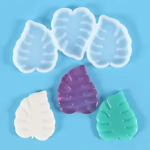 Detailed view of translucent leaf-shaped silicone mold with colorful resin samples