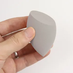 Macro detail of a soft gray slanted cut beauty blender sponge for makeup application
