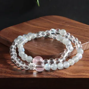 Macro detail of natural grey moonstone and clear quartz double-loop crystal bracelet