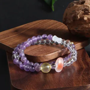 Macro view of double-strand amethyst bracelet with citrine and clear quartz beads