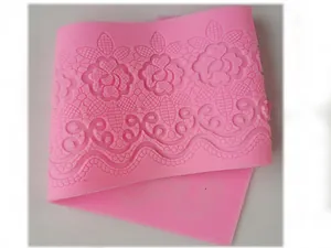Close-up of pink silicone fondant lace mold with intricate floral relief pattern