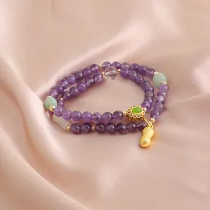 Bracciale a doppio filo in ametista con perle di giada e ciondolo arachide su raso