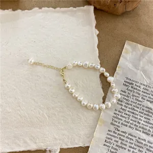 Exquisite detail of a vintage natural baroque pearl necklace on artistic paper