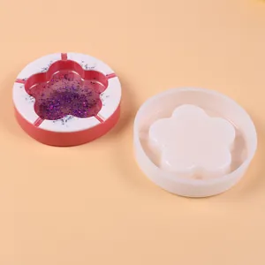 Plum blossom shaped silicone ashtray mold displayed with finished pink glitter resin sample