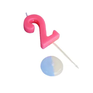 Large pink number 2 birthday candle with a round drip tray base for cake decoration