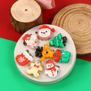 Detailed view of a Christmas themed silicone mold with mini resin Santa and tree figures