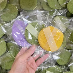 Set of three colorful facial cleansing puffs with ribbon handle in clear packaging