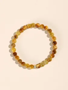 Detailed view of golden tiger's eye stone beads on a minimalist bracelet