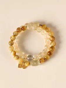 Double-strand yellow tiger eye and quartz beaded bracelet with gold-tone Pixiu charm.