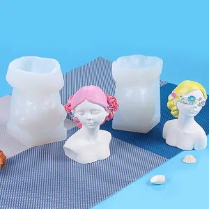 Macro view showing detailed girl bust silicone mold and finished plaster models