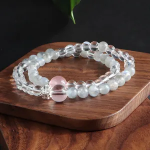 Close-up view of double-layer natural moonstone and clear quartz crystal bracelet
