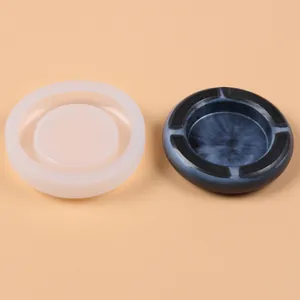 High-quality detailed view of circular silicone ashtray mold with a finished blue resin piece