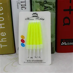 Detailed view of yellow spiral birthday candles in packaging for cake decoration