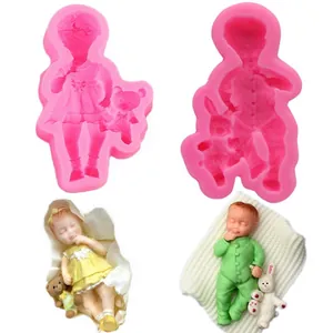 Detailed view of 3D baby silicone molds and finished resin figures for DIY crafts