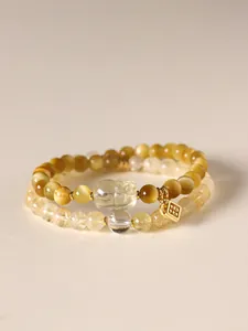 Detail view of double-layer bracelet with yellow tiger eye and citrine beads