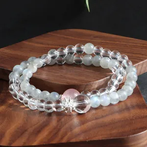 Close-up of natural crystal double-layer bracelet with moonstone and rose quartz beads