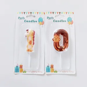 Close-up of cute cartoon giraffe and monkey birthday number candles in packaging
