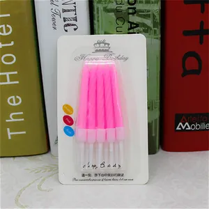 Pink spiral birthday candles with holders in blister packaging