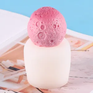 Dettaglio candela a forma di luna rosa e relativo stampo in silicone bianco per DIY